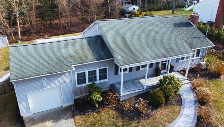 Aerial drone photo of an older Long Island home showing roof condition and attached garage